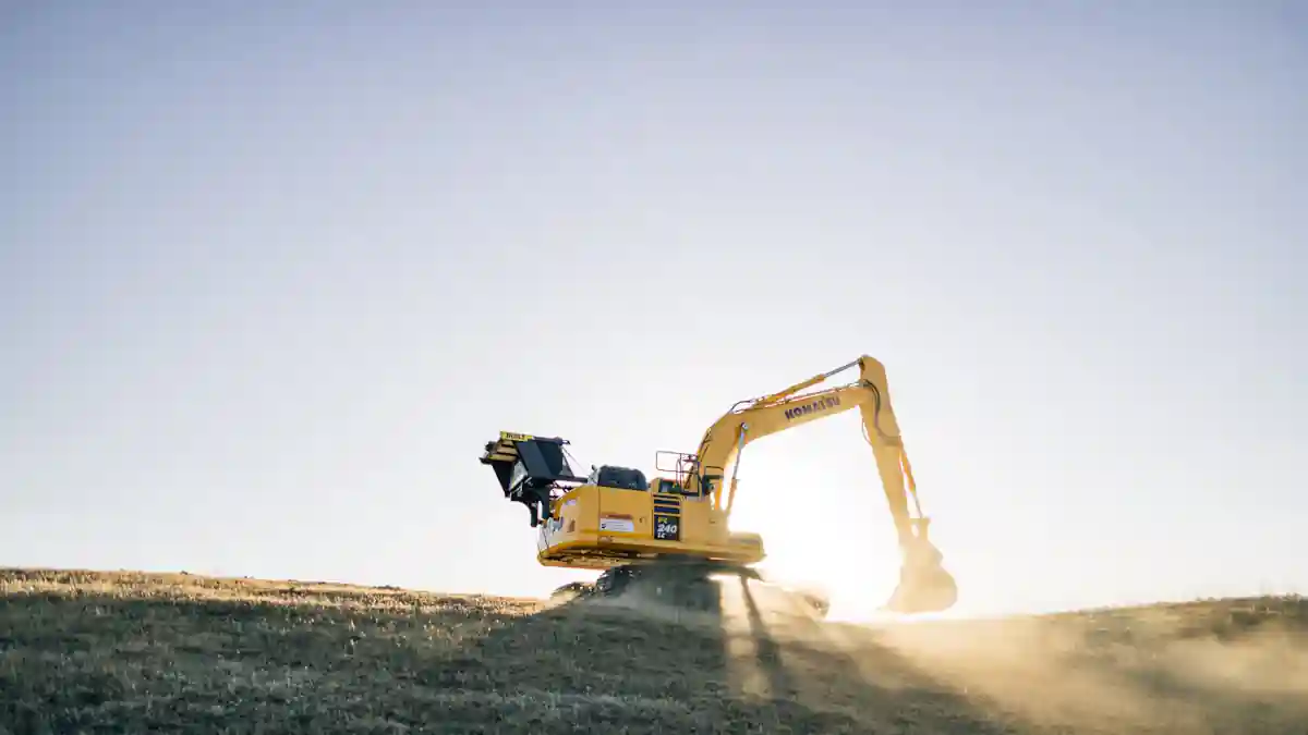 Excavator digging trench for French drain installation in Princeton TX